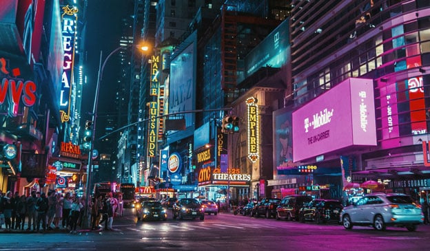 street at night with lots of brand names